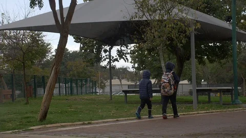 Kids walking back from school while it's rainy Stock Footage 86625208