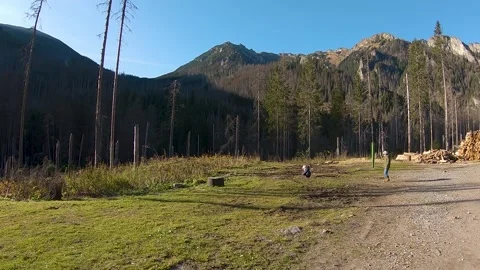 Kids walking over in front of trees and mountains in Zakopane, Poland Stock Footage 152845360