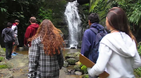 Kids walking to a waterfall Stock Footage 57650216