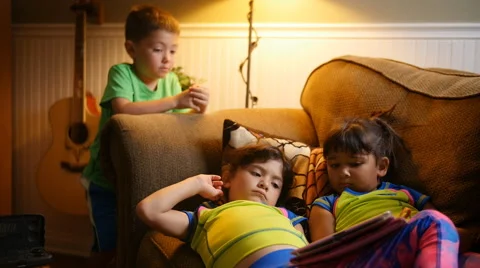 KIDS WATCH TABLET COMPUTER ON COUCHIN SLOW MOTION Stock-Footage 54622035
