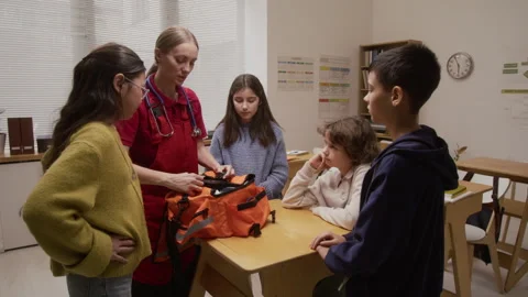 Kids Watching Interactive Presentation with Paramedic Stock Footage 328324911