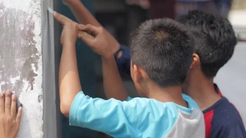 Kids working by a wall Stock Footage 75887260
