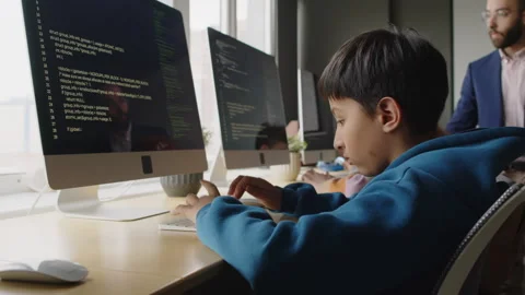 Kids Writing Programming Code on Desktop Computers and Teacher Checking Stock Footage 278127980