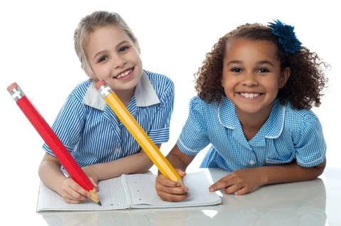 Kids writting their assignment Stock Photos