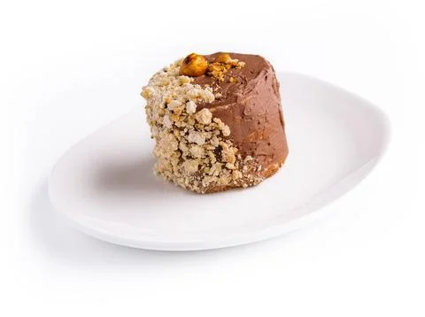 Kiev cake with walnuts on white plate Stock Photos