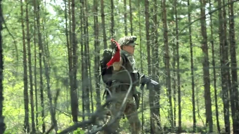 Killed armed soldier with red flag goes to recovery camp, military game airsoft Video stock 134479331