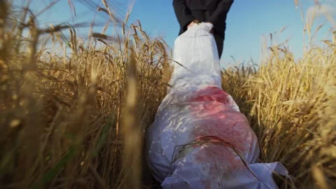 Killer dragging bleeding dead body Stock Footage 140529000