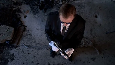 Killer with a gun in the building top view Stock Footage 75952970