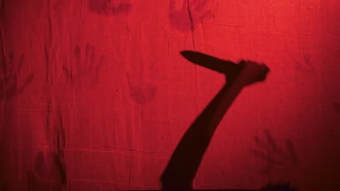 Killer With Knife Behind Red Curtain Video stock 252742673