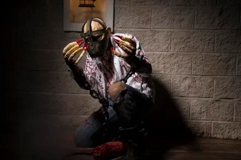 Killer, Man chained with blood and knife, has a severed leg blood Stock Photos