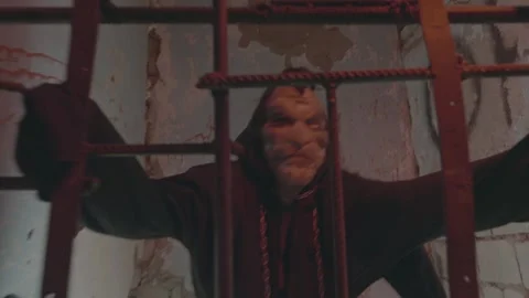 The killer or the executioner in the jail cell. Horror scene for halloween. High Stock Footage 237993789