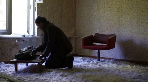 Killer in the post apocalyptic clothing comes in an abandoned room, strewn with 스톡 동영상 67986089
