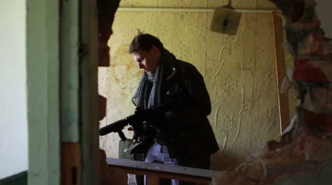 Killer in the post apocalyptic clothing comes in an abandoned room, preparing Stock Footage 67991809
