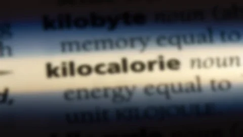 Kilocalorie word in a dictionary. Stock Footage 99561917