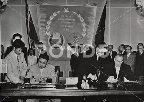 Kim Il Sung and Otto Grotewohl signing documents in a meeting - 1956 Stock Photos
