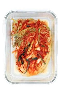 Kimchi cabbage in a glass rectangular bowl isolated in white background, top Stock Photos