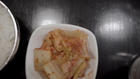 Kimchi on table over head slow motion close up Williamsburg BK NYC Vídeos de archivo 274844443