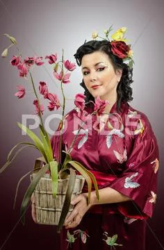Kimono caucasian woman holding an orchid Stock Photos
