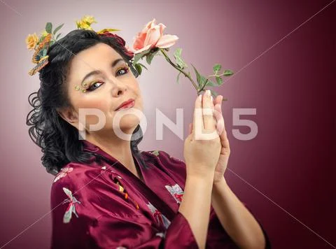 Kimono caucasian woman holding pink rose Stock Photos