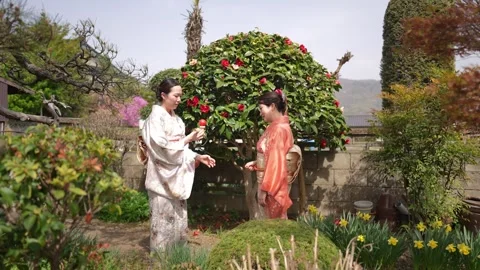 Kimono-Clad People Looking at Red Ball String Toy Stockbeeldmateriaal 344854823