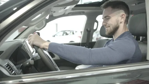 A kind of closeup of a happy man sits in a new car. Stock Footage 101114249
