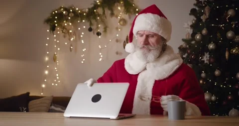 Kind elderly Santa Claus taking off his glasses after long online work at home Stock Footage 166588713
