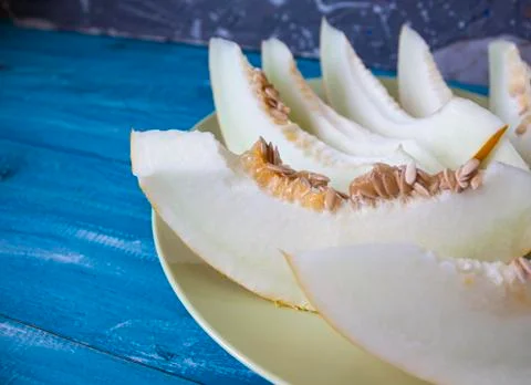 Kind of melon straight. melon sliced ??on a blue background. Stock Photos