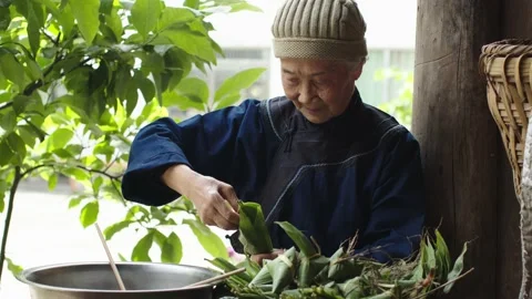 The kind old lady taught two children to make dumplings Stock Footage 232152823