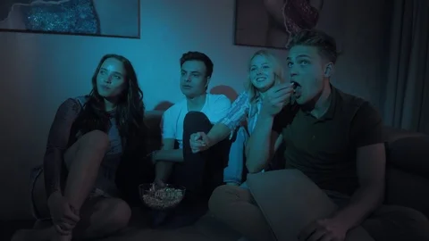 Kind positive young friends two girls and two guys watching comedy Stock Footage 116175083