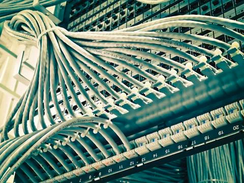 Kind of wiring closet patch panels with 6-th category in the background Foto stock
