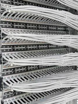 Kind of wiring closet patch panels with 6-th category in the background ki... Stock-Fotos