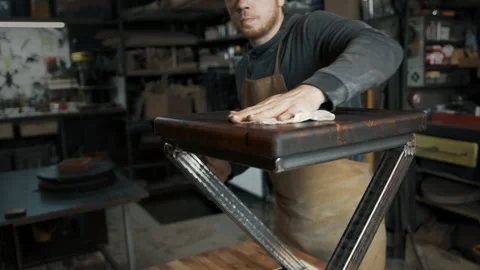 The kind worker wipes a loft-style chair with a rag Stock Footage 142250127