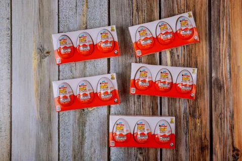 Kinder Surprise Egg between many chocolate egg is a sweet present by Italian  Stock Photos