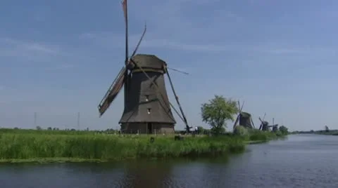 Kinderdijk windmills pumping, view from canal - vehicle shot Stock Footage 22418072
