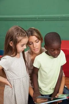 Kindergarten class reading a book 스톡 사진
