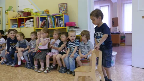 Kindergarten students sitting together. Stock Footage 132346478