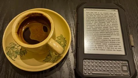 Kindle ebook reader with a cup of coffee in a cafe Stock Photos
