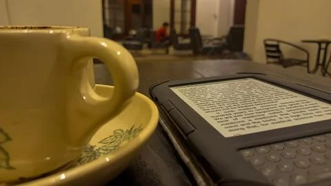 Kindle ebook reader with a cup of coffee in a cafe Stock Photos