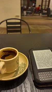 Kindle ebook reader with a cup of coffee in a cafe Stock Photos
