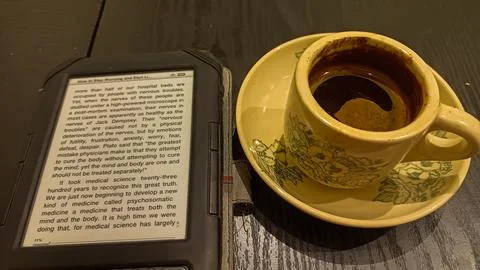 Kindle ebook reader with a cup of coffee in a cafe Stock Photos