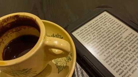 Kindle ebook reader with a cup of coffee in a cafe Stock Photos