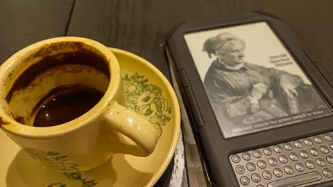 Kindle ebook reader with a cup of coffee in a cafe Stock Photos