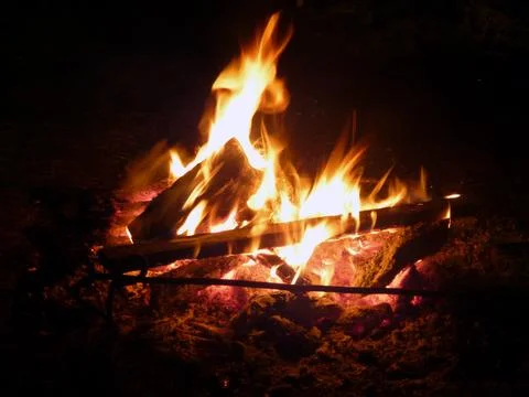 A kindled fire is burning on a dark background close-up Stock Photos