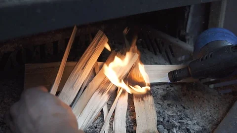 Kindles fire, sets fire to wood, Flame and fire in the grill, barbecue in the su Stock Footage 111085014