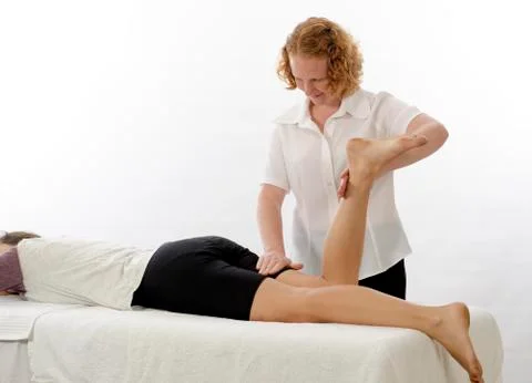 Kinesiologist treating hamstrings Stock Photos