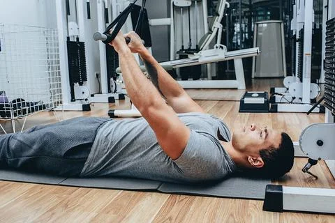 Kinesitherapy, a mixed race man is training in a wellness center, on special  写真素材