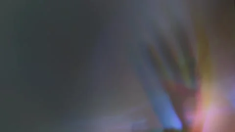 Kinetic Glow: Hands and Refracted Light Stock Footage 302411306