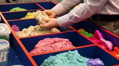 Kinetic sand of different colors demonstrating Stock Footage 53807531