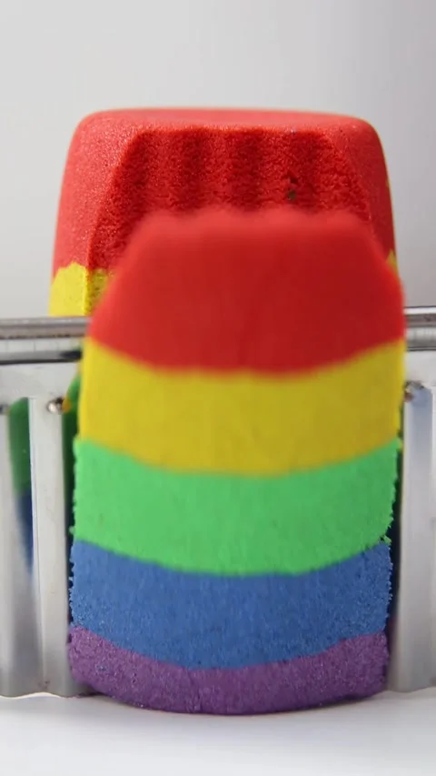 Kinetic sand of rainbow colors red yellow green blue violet . Stock Footage 254945804