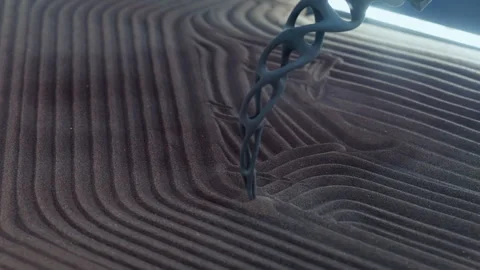 Kinetic table as functional art creates mesmerizing visual display on sand with Stock Footage 346610547